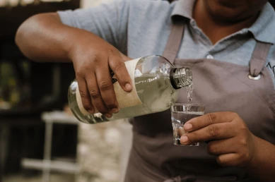 local-artisan-pouring-artisanal-mezcal-260nw-2788666119